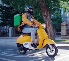 Scooter delivery rider on the road